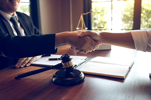 Lawyer is currently shaking hands with the client about the succ